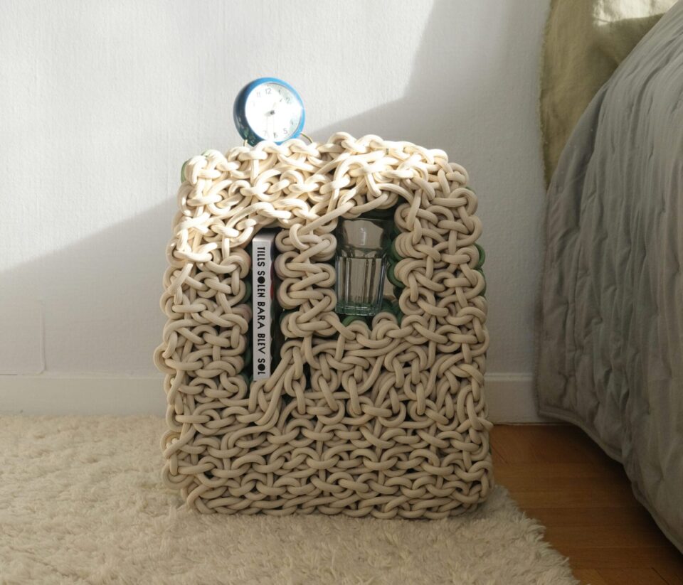 a small side table with niches for objects, made from beige nylon rope