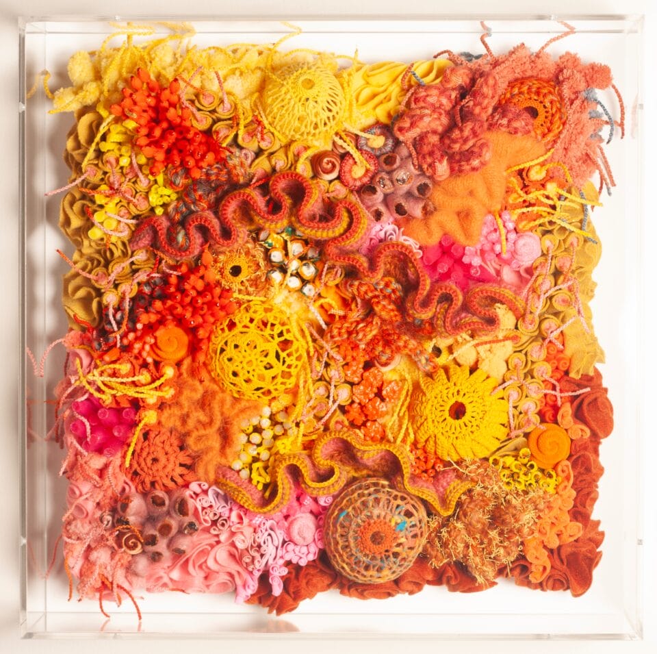a vibrant fiber work evoking corals, molds, and other organic forms